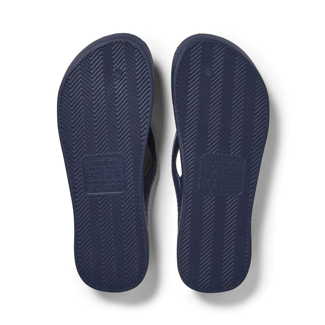 Archies Arch Support Thongs in navy pictured upside down from the bottom