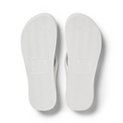 Archies Arch Support Thongs in white shimmer pictured upside down from the bottom